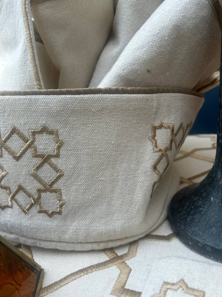 The Arabesque Table Set - 15 Piece Bronze Embroidered set from Raw Cotton placed in a handmade basket with leather handles. This picture shows the bread basket.