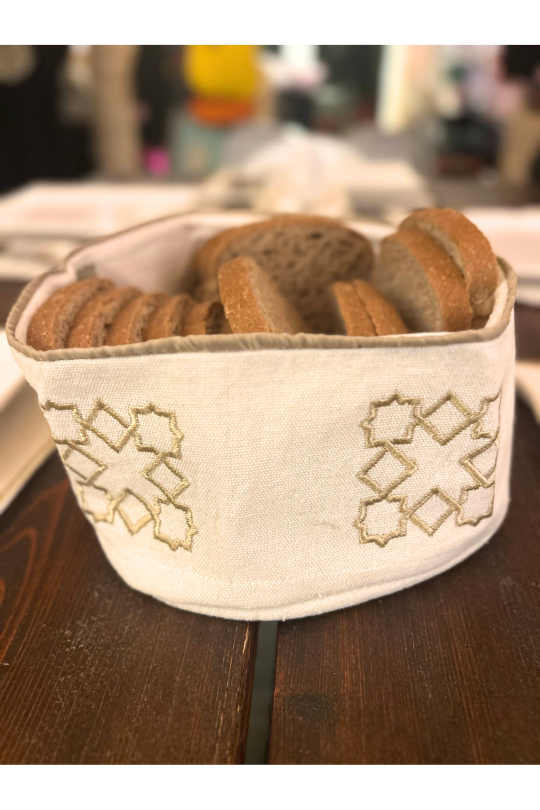 The Arabesque Table Set - 15 Piece Bronze Embroidered set from Raw Cotton placed in a handmade basket with leather handles. This picture shows the bread basket.