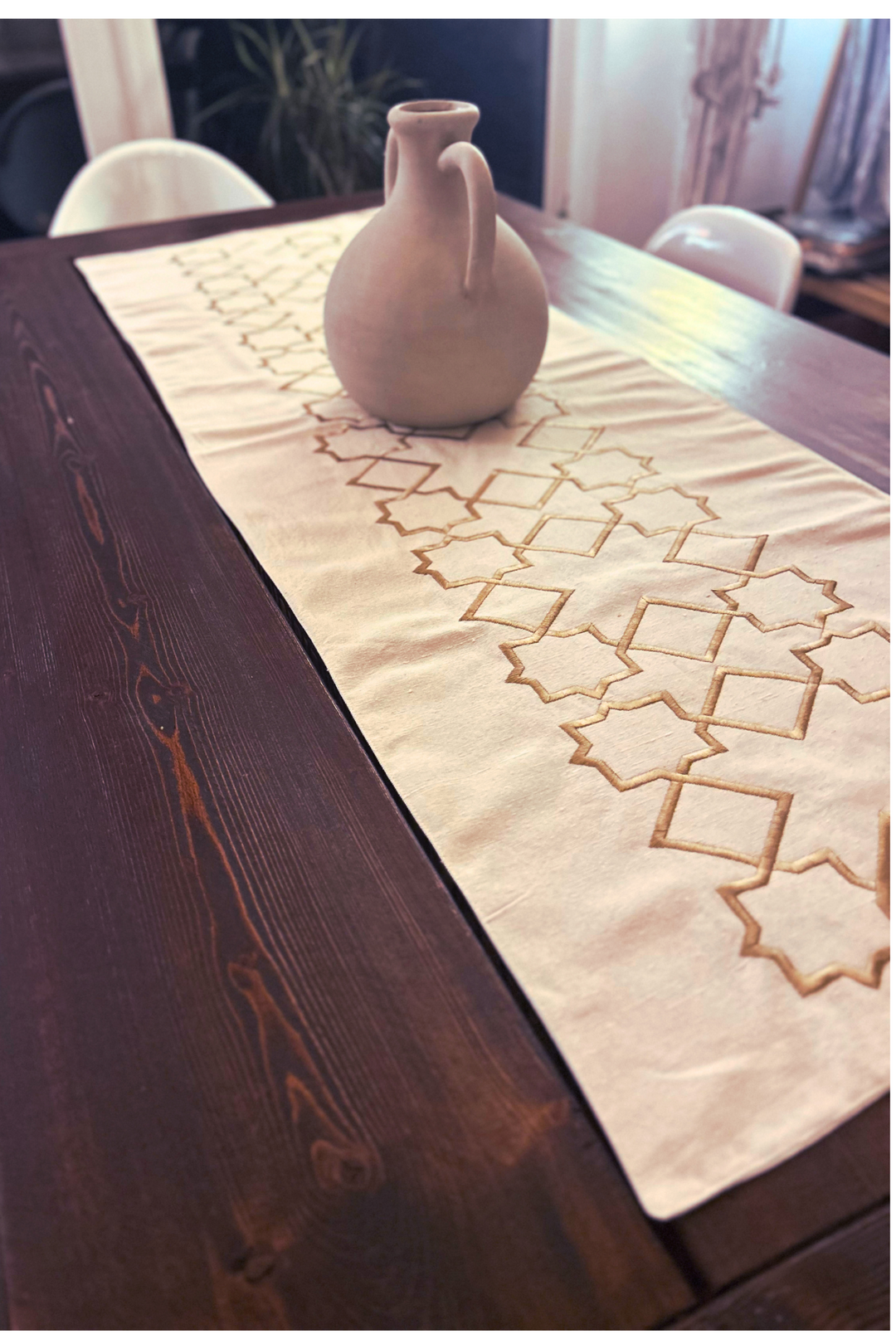 The Arabesque Table Set - 15 Piece Bronze Embroidered set from Raw Cotton placed in a handmade basket with leather handles. This picture shows the runner.