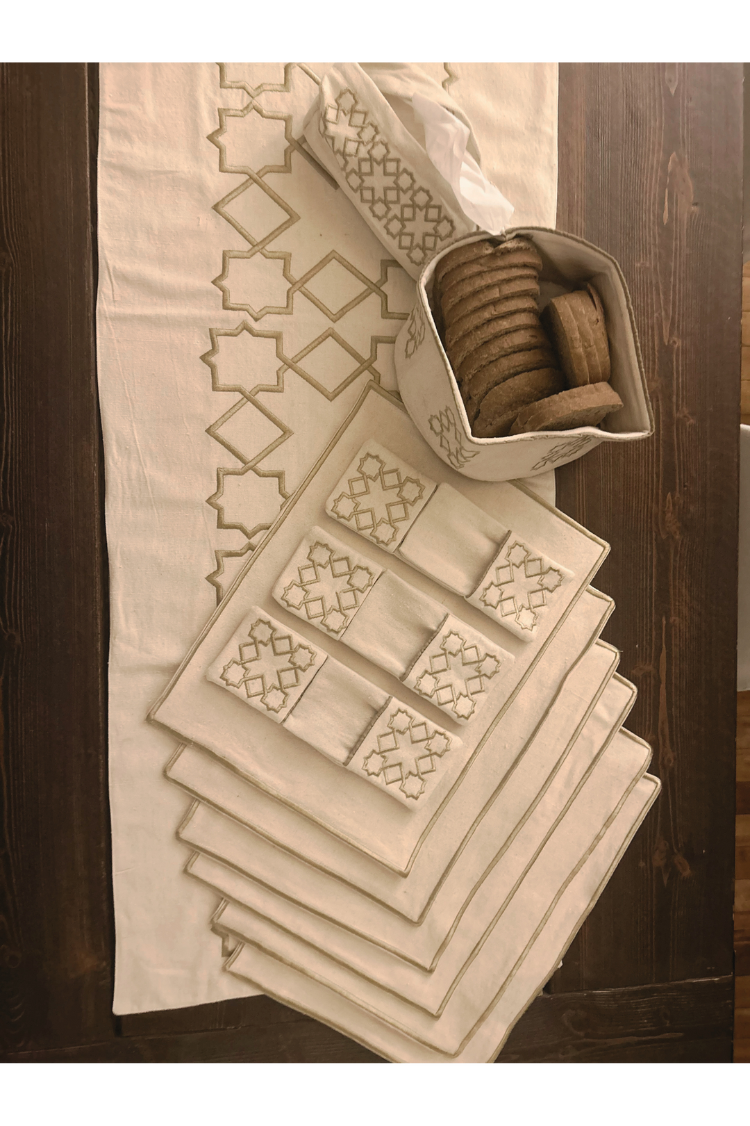 The Arabesque Table Set - 15 Piece Bronze Embroidered set from Raw Cotton placed in a handmade basket with leather handles. 