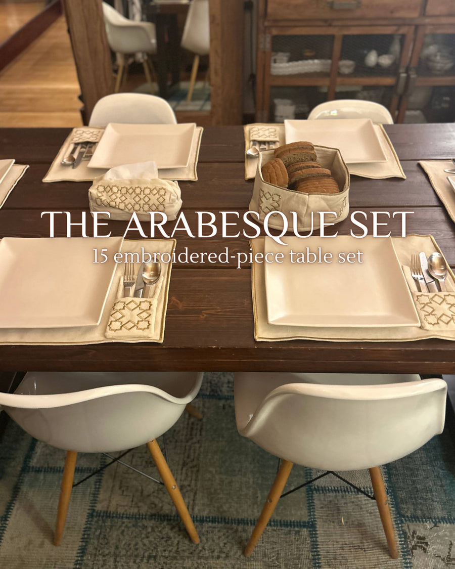 The Arabesque Table Set - 15 Piece Bronze Embroidered set from Raw Cotton placed in a handmade basket with leather handles