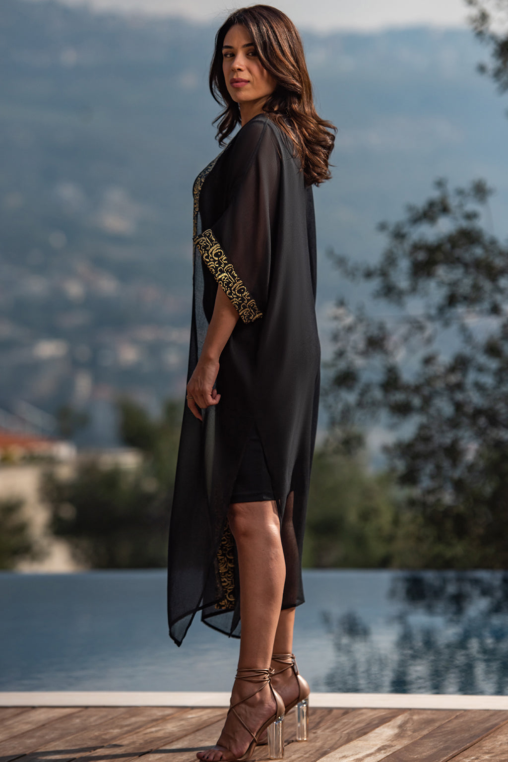 Najaf Whispers Black Kaftan
Adorned with goldish Arabic calligraphy