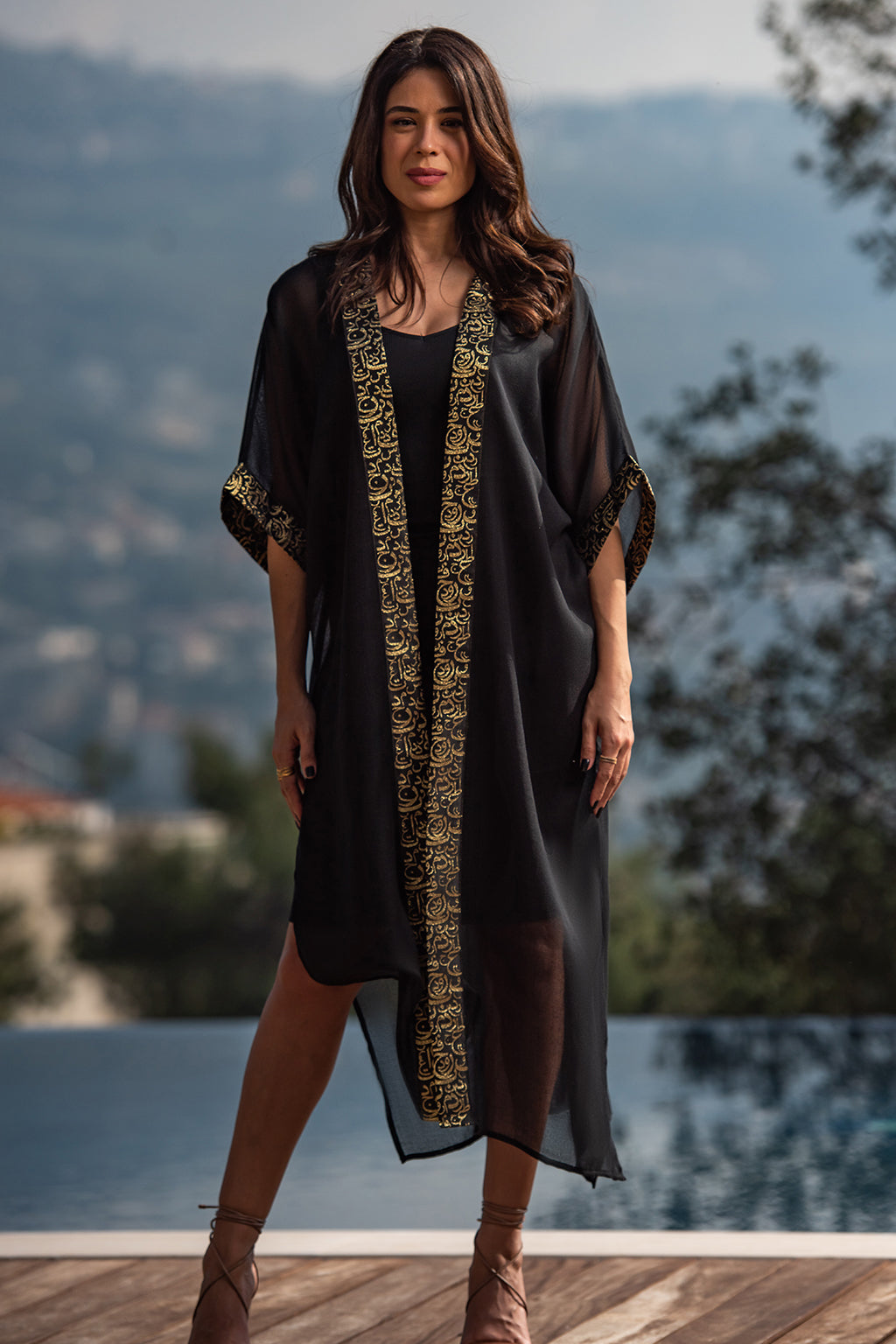 Najaf Whispers Black Kaftan
Adorned with goldish Arabic calligraphy